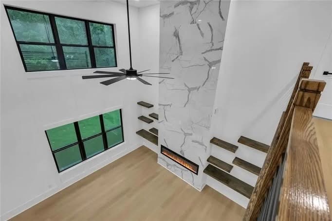 Two-story living space, staircase, and fireplace